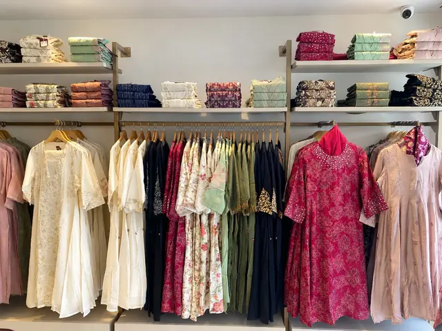 Feature wall with folded stock on shelves above and garment rails below