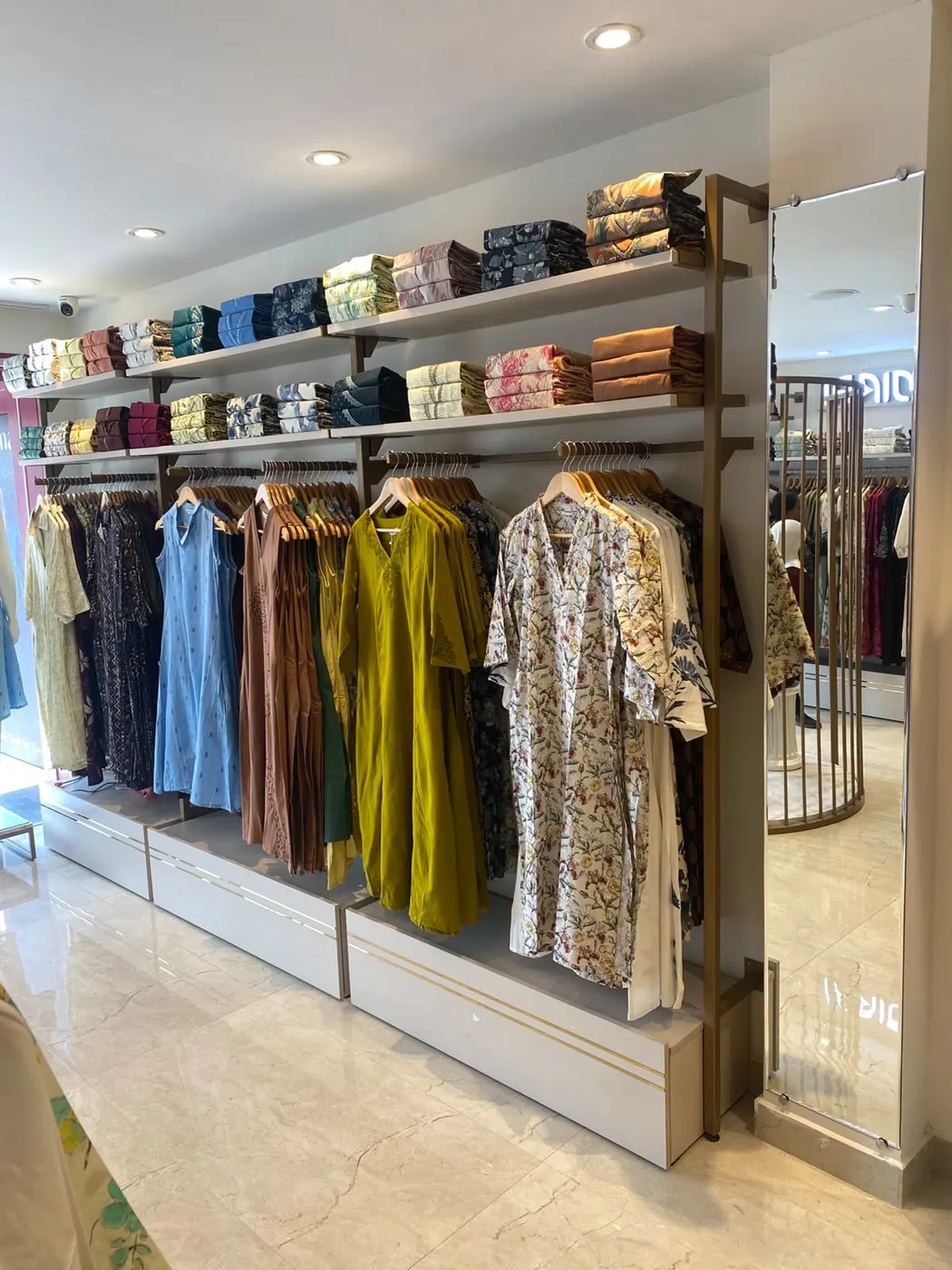 Vismay Chennai: wall shelving and hanging rails under recessed lights